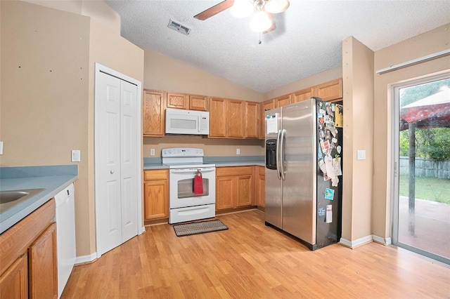 kitchen featuring ceiling fan, a textured ceiling, white appliances, vaulted ceiling, and light hardwood / wood-style flooring