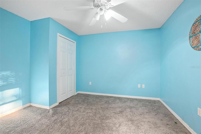 spare room with carpet, ceiling fan, and a textured ceiling