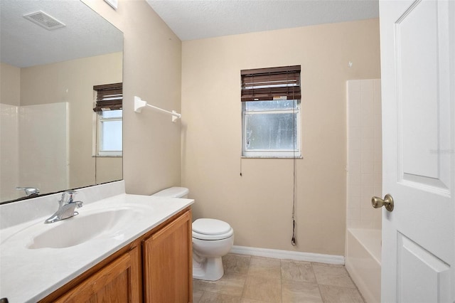 full bathroom featuring vanity, toilet, a wealth of natural light, and a textured ceiling