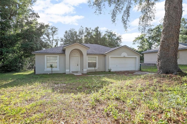 single story home featuring a garage and a front lawn