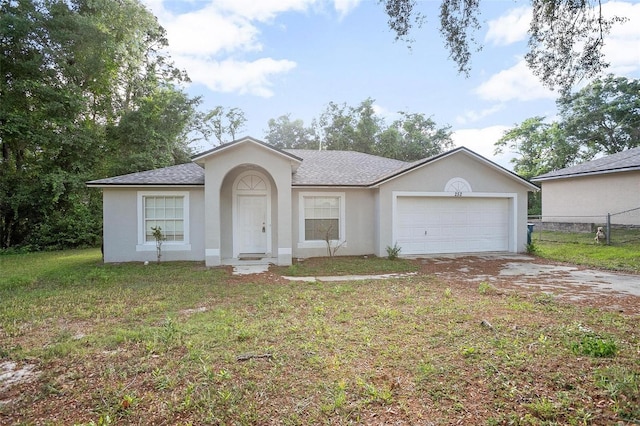 ranch-style house featuring a garage and a front yard