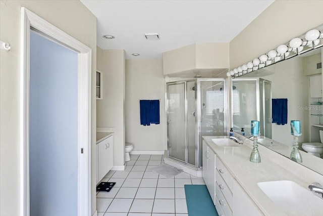 bathroom with walk in shower, toilet, tile floors, and dual vanity