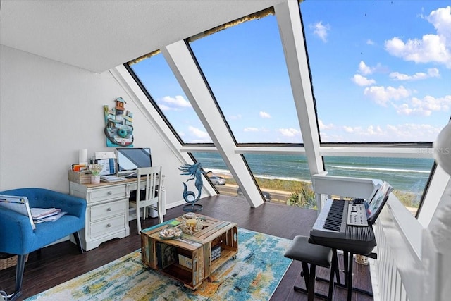 interior space featuring a water view and lofted ceiling with skylight