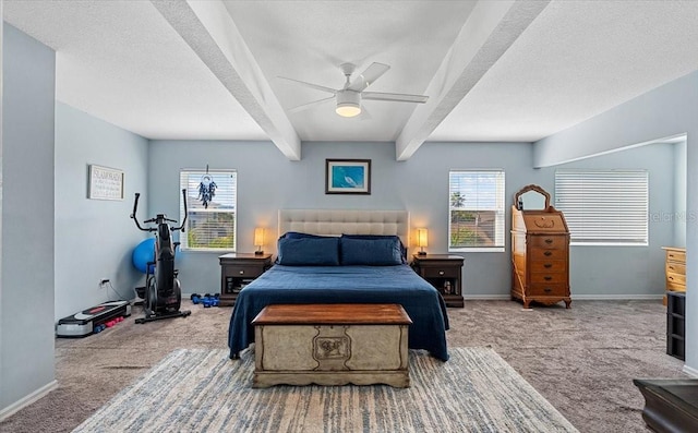 carpeted bedroom featuring ceiling fan, a textured ceiling, and beamed ceiling