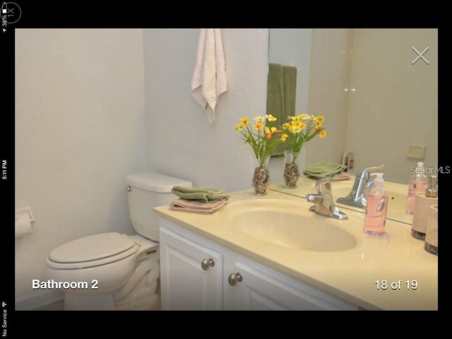 bathroom featuring vanity and toilet