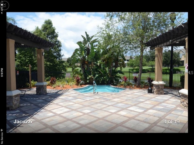 view of swimming pool featuring a pergola and a patio