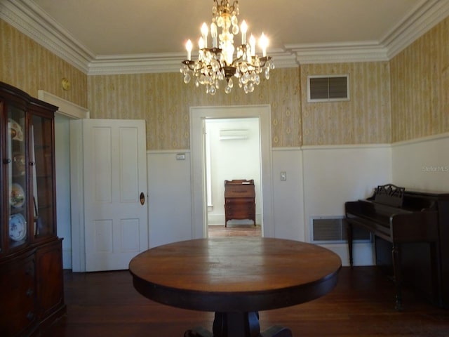 dining room featuring an inviting chandelier, crown molding, dark hardwood / wood-style flooring, and a wall unit AC