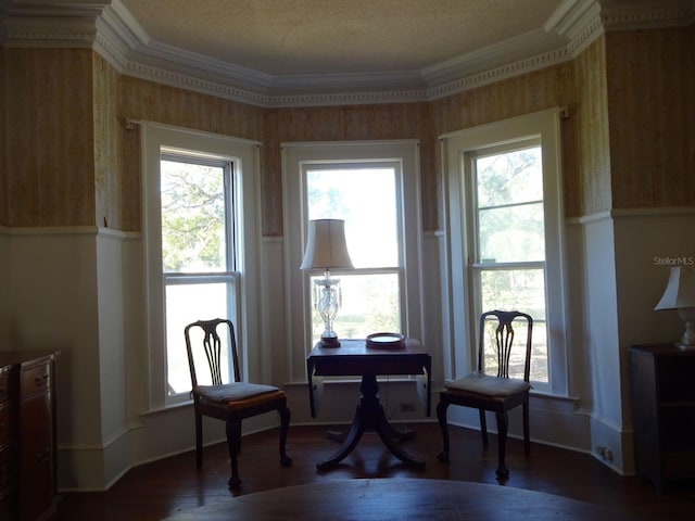 sitting room with crown molding, plenty of natural light, and dark hardwood / wood-style flooring