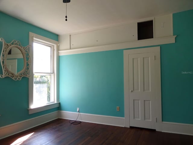 empty room with dark wood-type flooring