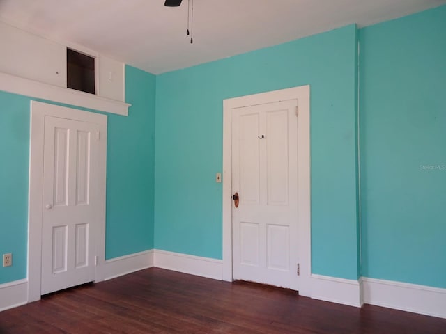 unfurnished room with ceiling fan and dark hardwood / wood-style flooring