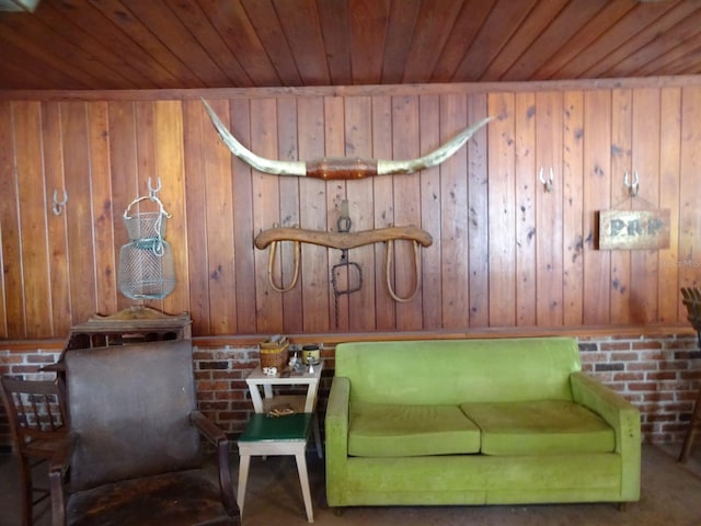 sitting room featuring wood walls and wooden ceiling