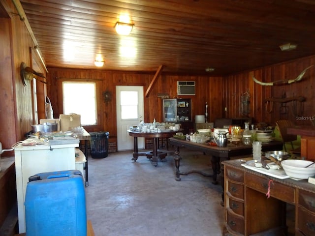 office area with concrete floors, wooden ceiling, wooden walls, and a wall mounted air conditioner