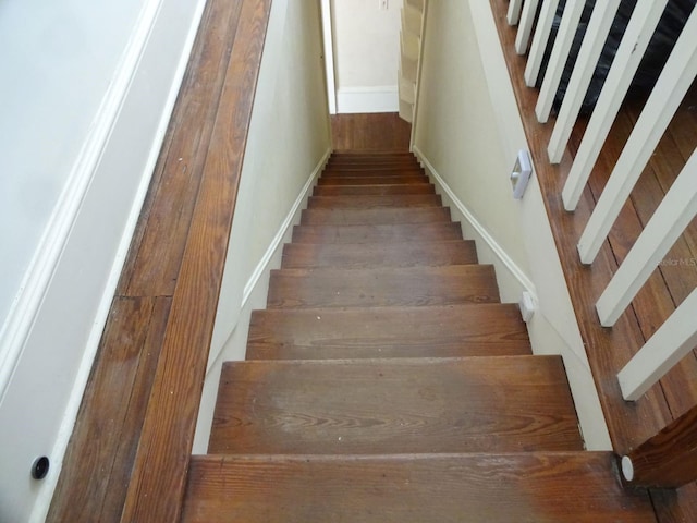 stairs featuring dark hardwood / wood-style floors