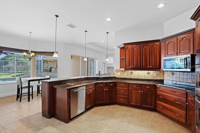 kitchen featuring an inviting chandelier, decorative light fixtures, appliances with stainless steel finishes, and light tile floors