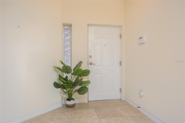 entryway with light tile patterned flooring