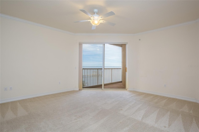 carpeted empty room featuring ceiling fan and ornamental molding