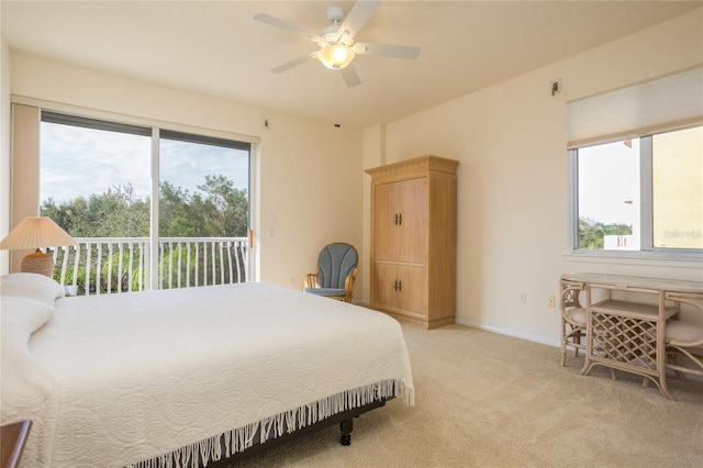 carpeted bedroom featuring access to exterior, multiple windows, and ceiling fan