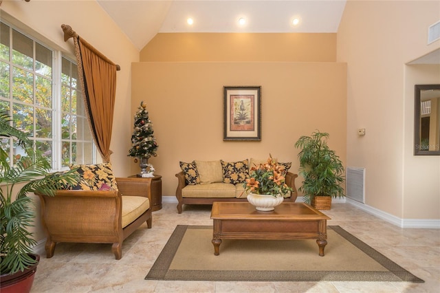 living room with high vaulted ceiling