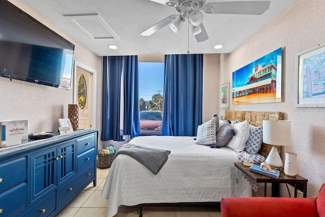 tiled bedroom with ceiling fan and a textured ceiling