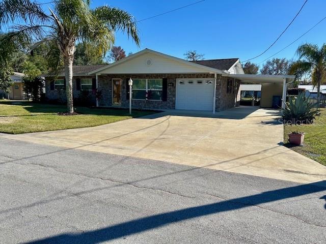 single story home with a front lawn and a garage