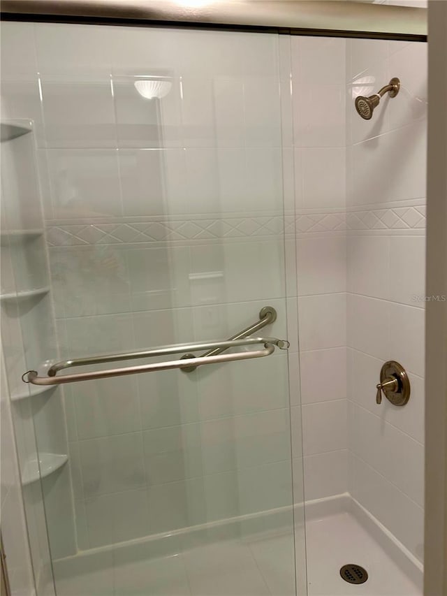 bathroom featuring a shower with door