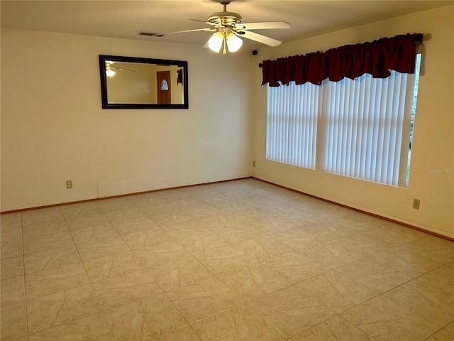 unfurnished room with ceiling fan