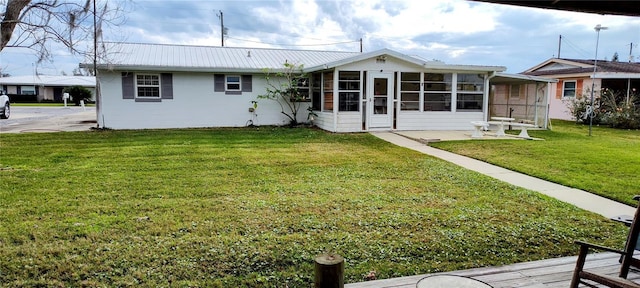 rear view of house featuring a lawn