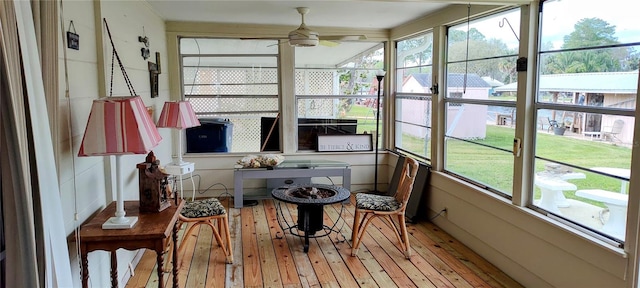 sunroom featuring ceiling fan