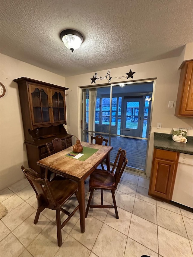 tiled dining room with a textured ceiling