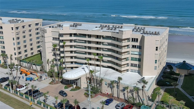 view of property with a beach view and a water view