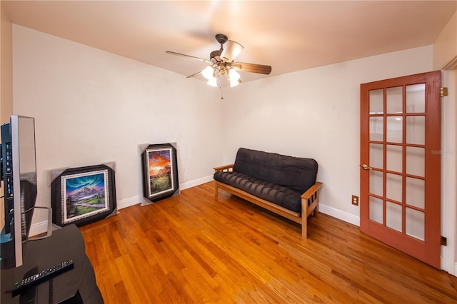 sitting room with ceiling fan and light hardwood / wood-style flooring