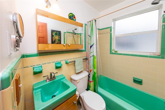 full bathroom featuring toilet, vanity, tasteful backsplash, tile walls, and shower / tub combo with curtain