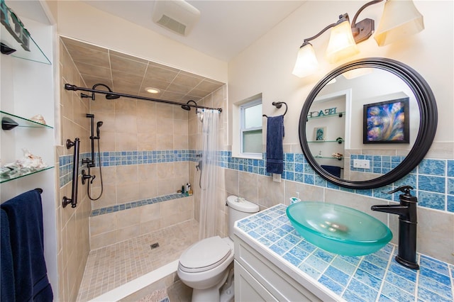 bathroom featuring toilet, vanity, tasteful backsplash, curtained shower, and tile walls