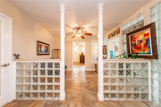 hallway featuring light tile floors and ornate columns