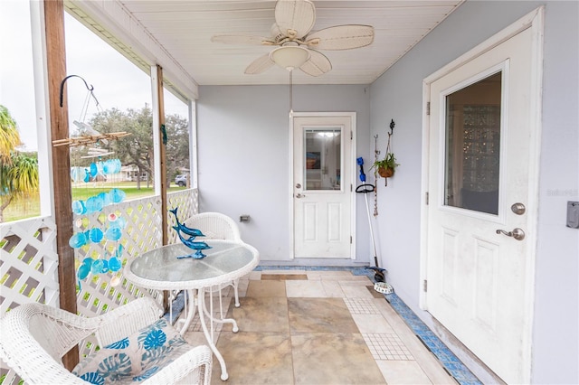 sunroom / solarium featuring ceiling fan