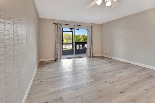 unfurnished room with a ceiling fan, baseboards, and wood finished floors