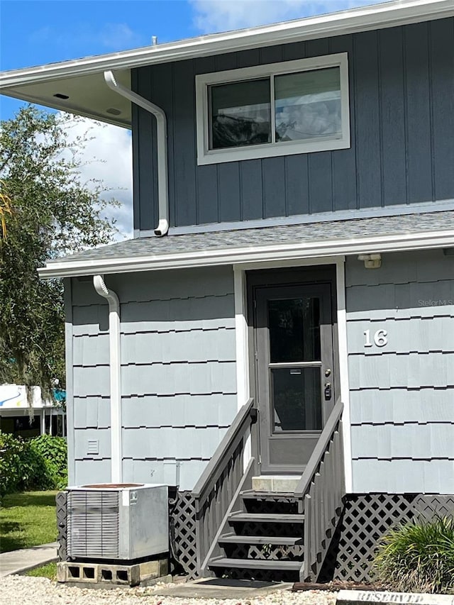 view of exterior entry featuring central AC