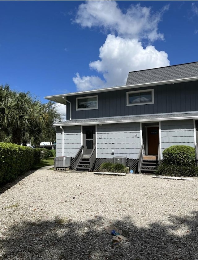 view of front of house featuring entry steps, roof with shingles, and central air condition unit