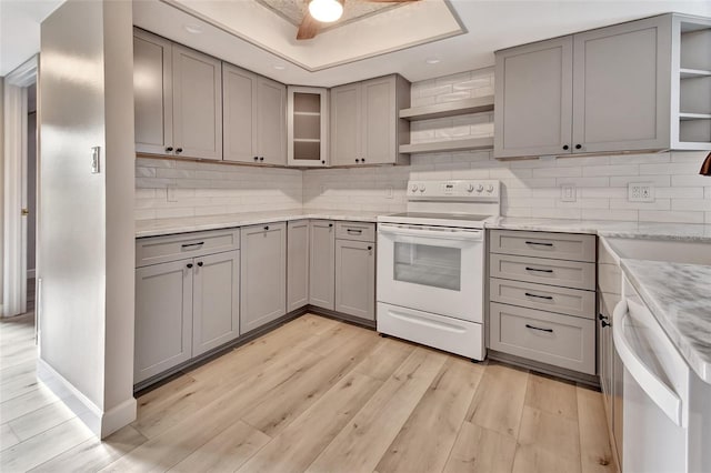 kitchen featuring white range with electric stovetop, open shelves, gray cabinetry, light wood-style floors, and dishwasher