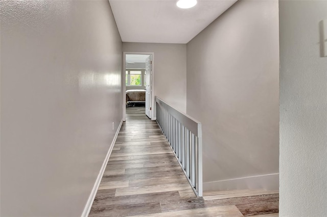 stairway featuring baseboards and wood finished floors