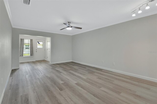 empty room with crown molding, ceiling fan, and light hardwood / wood-style floors