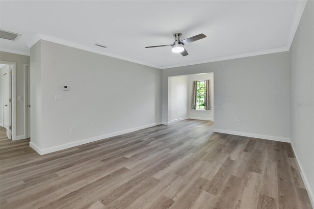 spare room featuring ceiling fan, light hardwood / wood-style floors, and crown molding