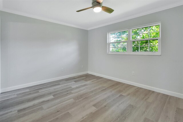 spare room featuring light wood-type flooring, ornamental molding, and ceiling fan