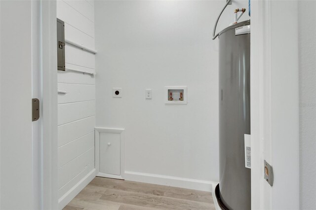 clothes washing area with washer hookup, water heater, hookup for an electric dryer, and light hardwood / wood-style floors