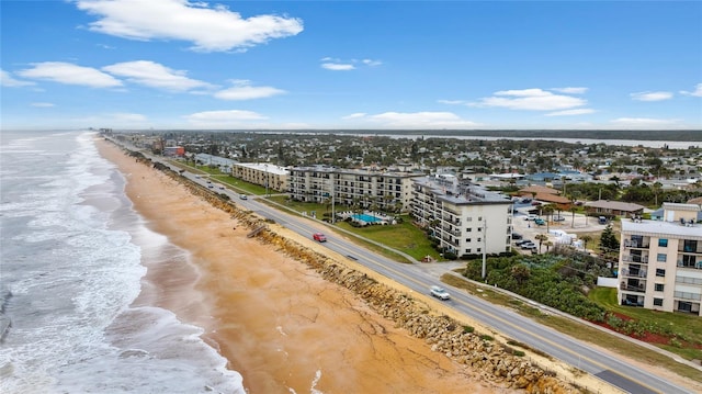 bird's eye view with a water view and a beach view