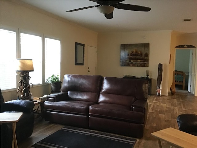 living room featuring ceiling fan and dark hardwood / wood-style flooring