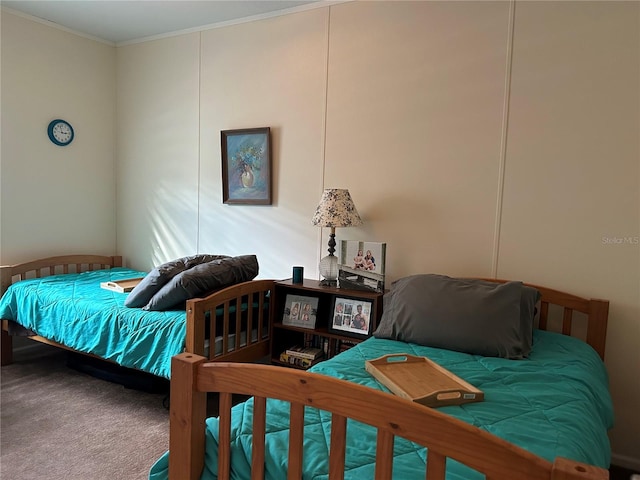 bedroom with ornamental molding and carpet