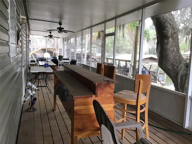 sunroom featuring ceiling fan