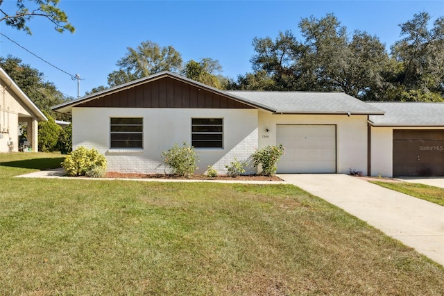 ranch-style house with a front yard and a garage