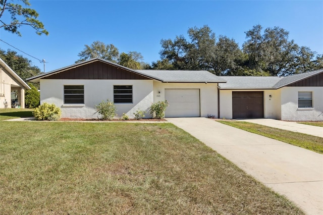 ranch-style house featuring a front yard and a garage